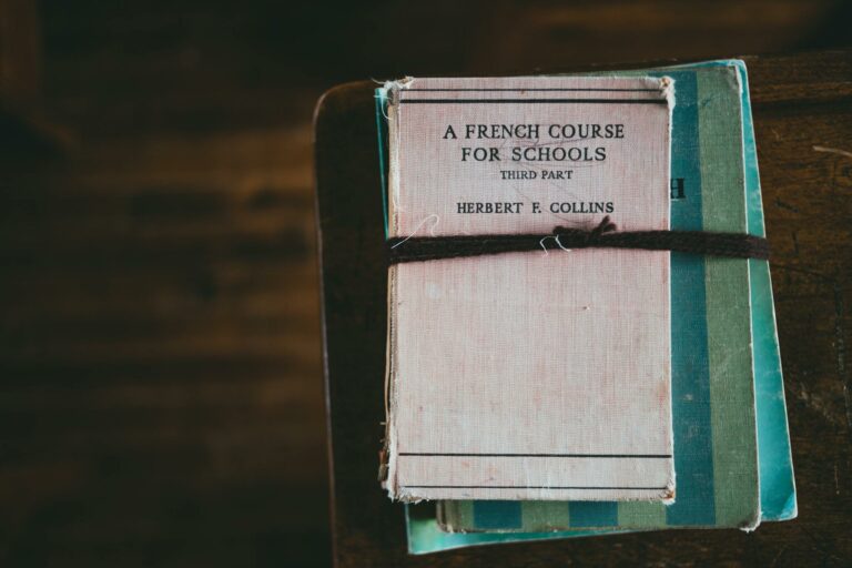 A vintage French language coursebook tied with string, evokes educational nostalgia.